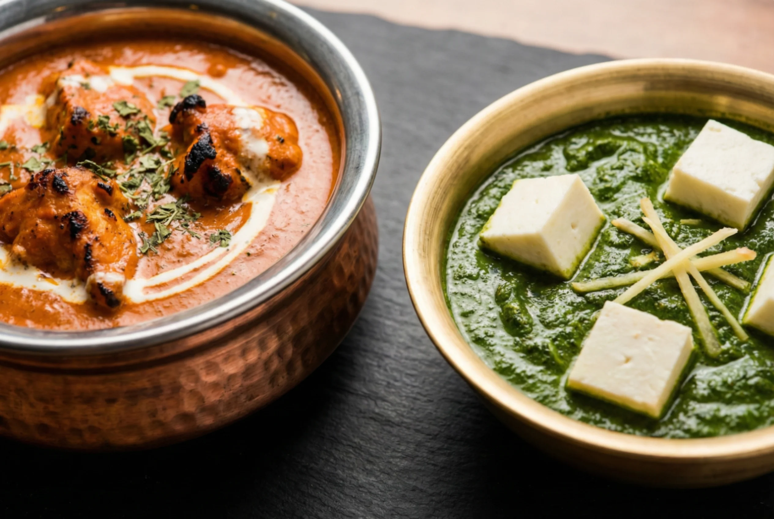 Butter chicken and palak paneer served without rice or naan, showing rich creamy sauces